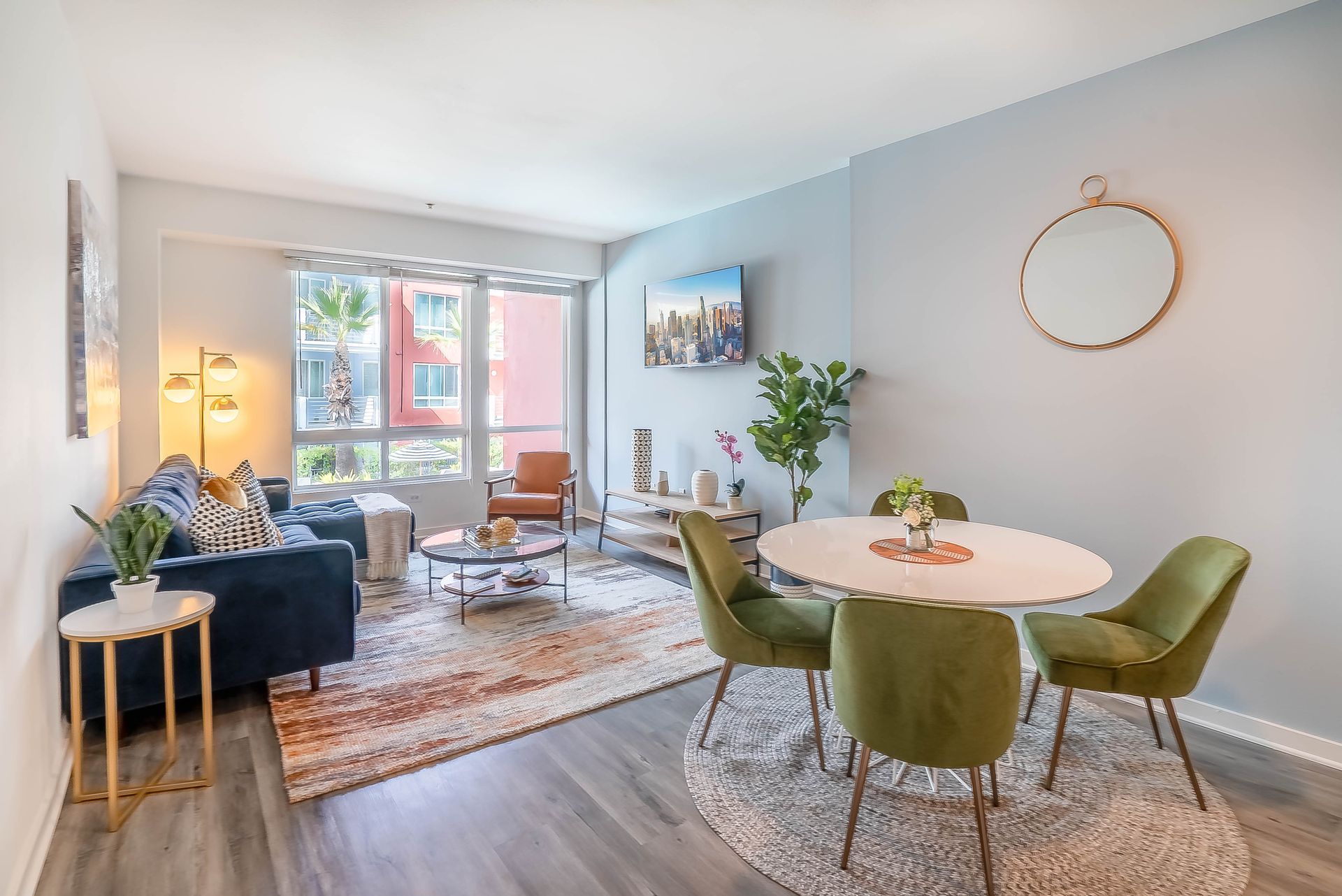 A living room with a couch , table and chairs.