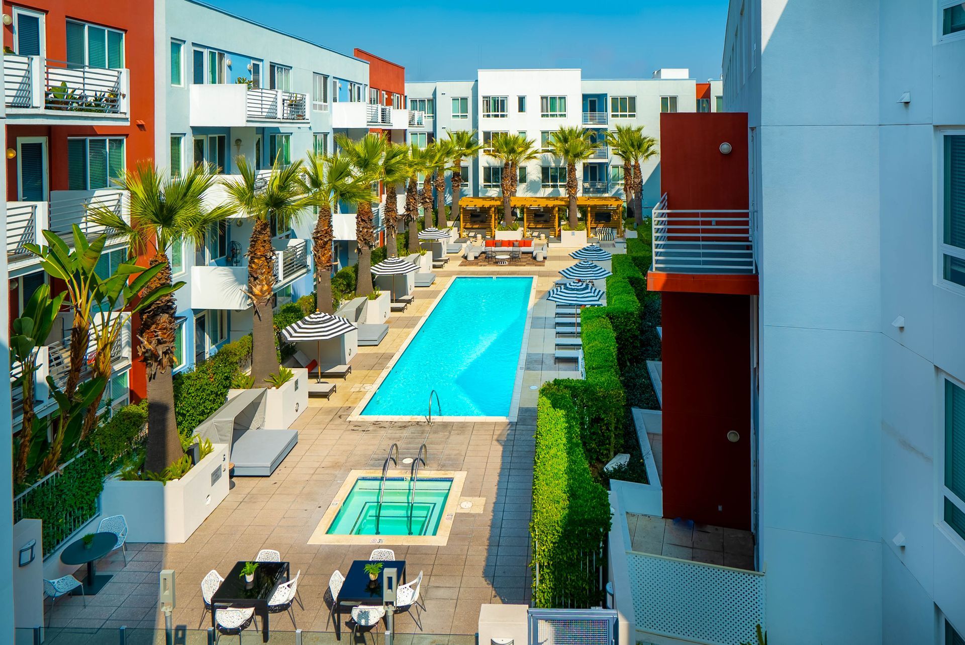 An aerial view of a large swimming pool surrounded by buildings.
