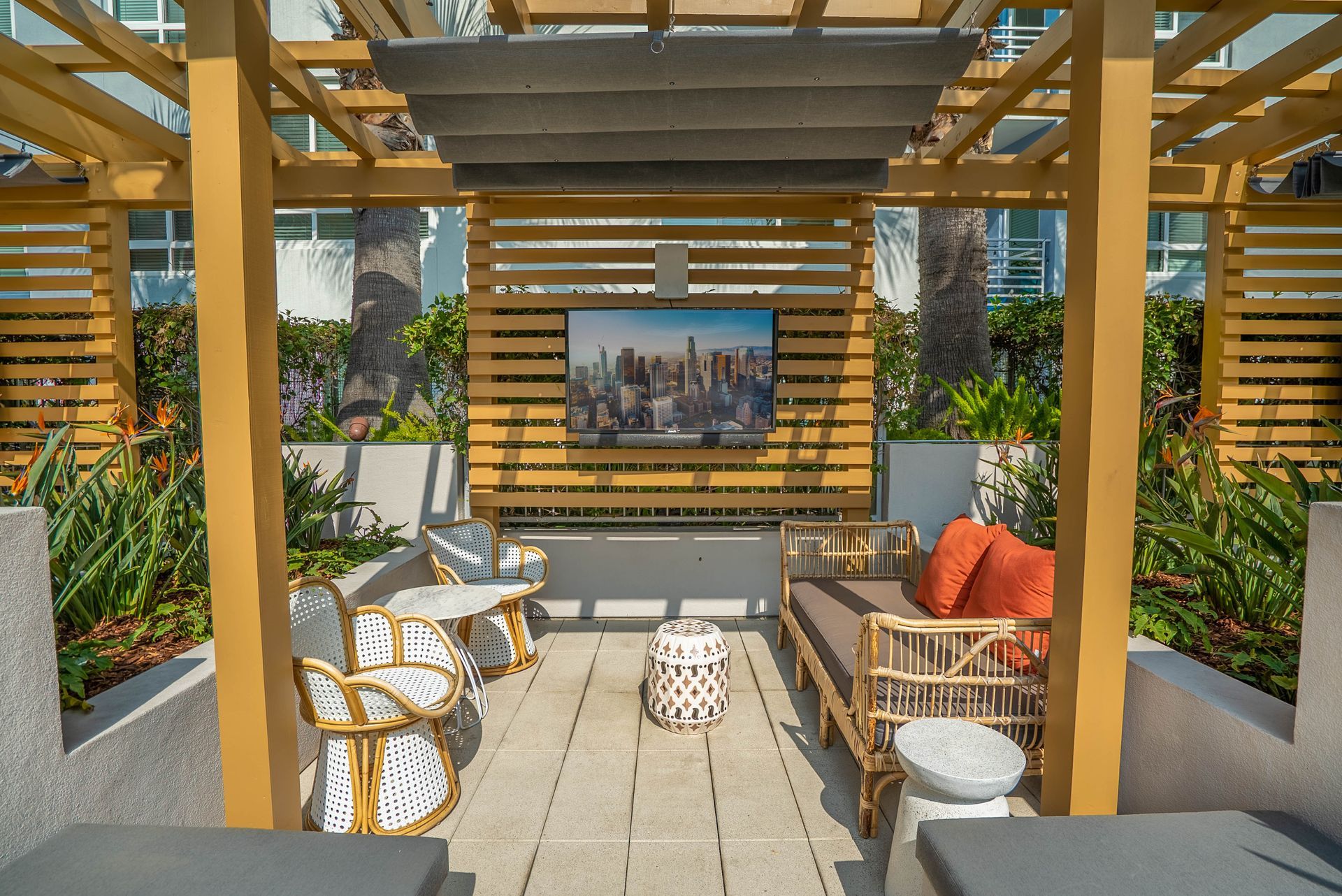 A pergola with a flat screen tv mounted on the wall.