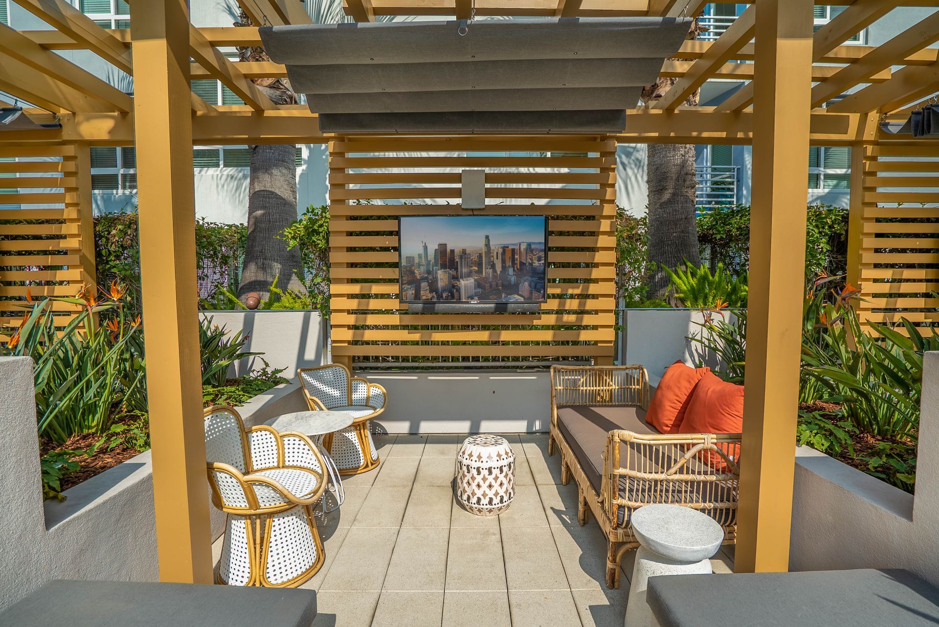 A pergola with a flat screen tv mounted on the wall.