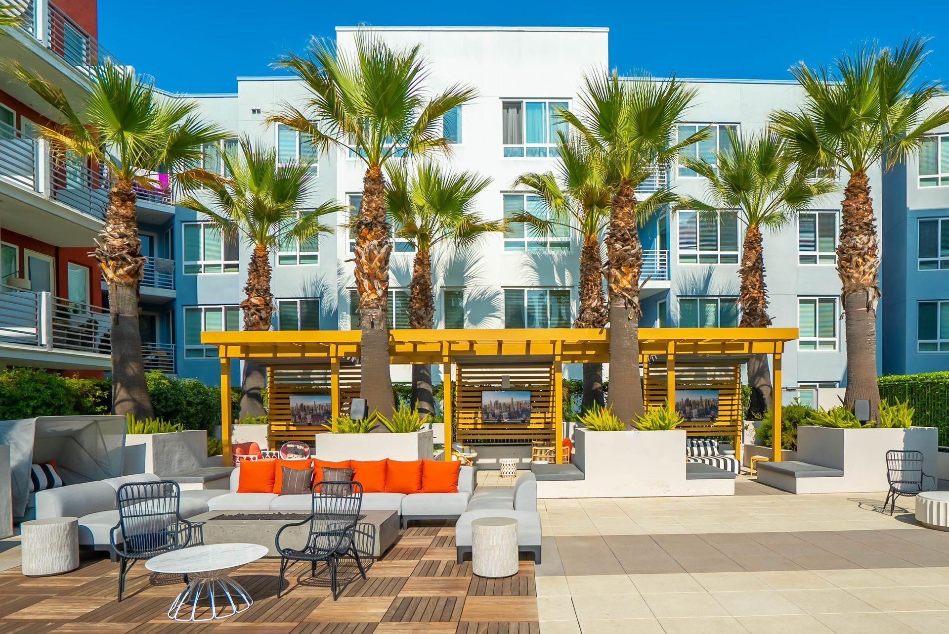A large building with a lot of palm trees in front of it.