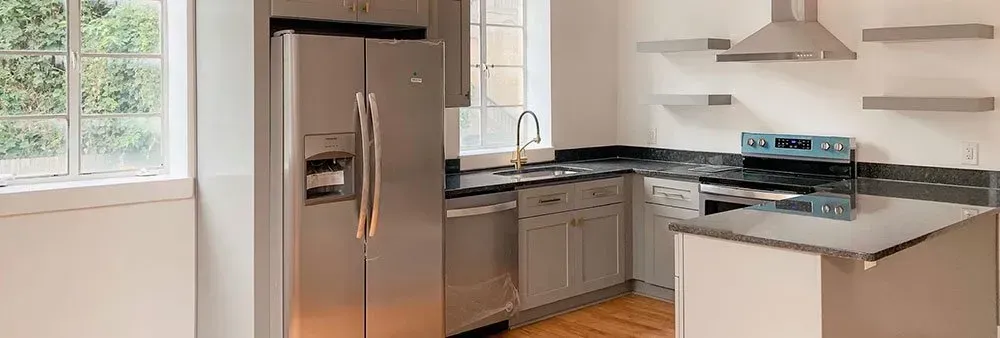 A kitchen with a stainless steel refrigerator , stove , dishwasher and sink.