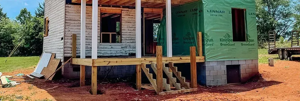 A house is being built with a porch and stairs.