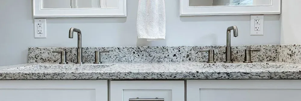 A bathroom with two sinks and two mirrors.