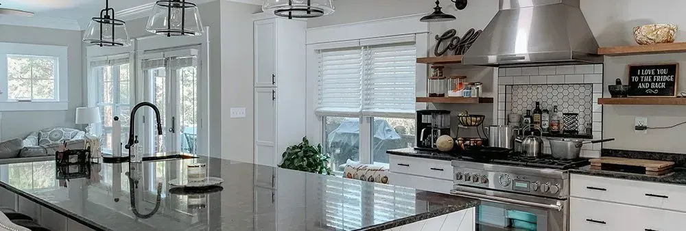 A kitchen with stainless steel appliances and a large island.