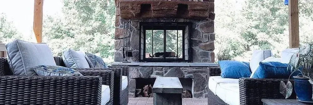 There is a fireplace in the middle of the living room.
