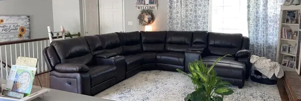 There is a large sectional couch in the middle of the living room.