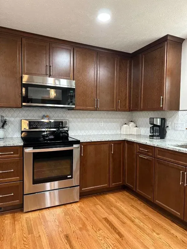 A kitchen with wooden cabinets and stainless steel appliances.