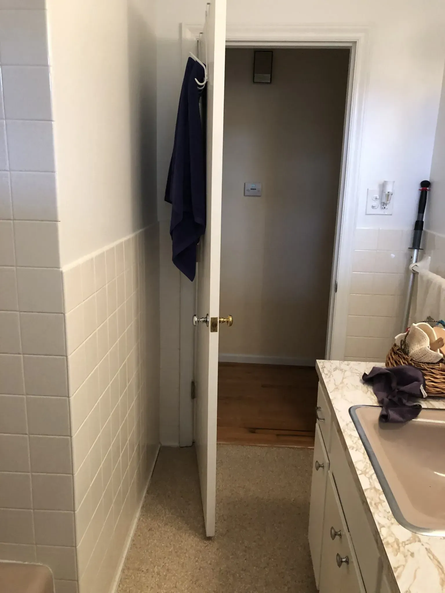 A bathroom with a sink and a door that is open