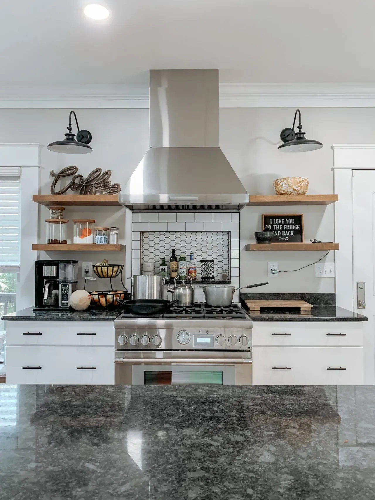 A kitchen with stainless steel appliances and a stove top oven.