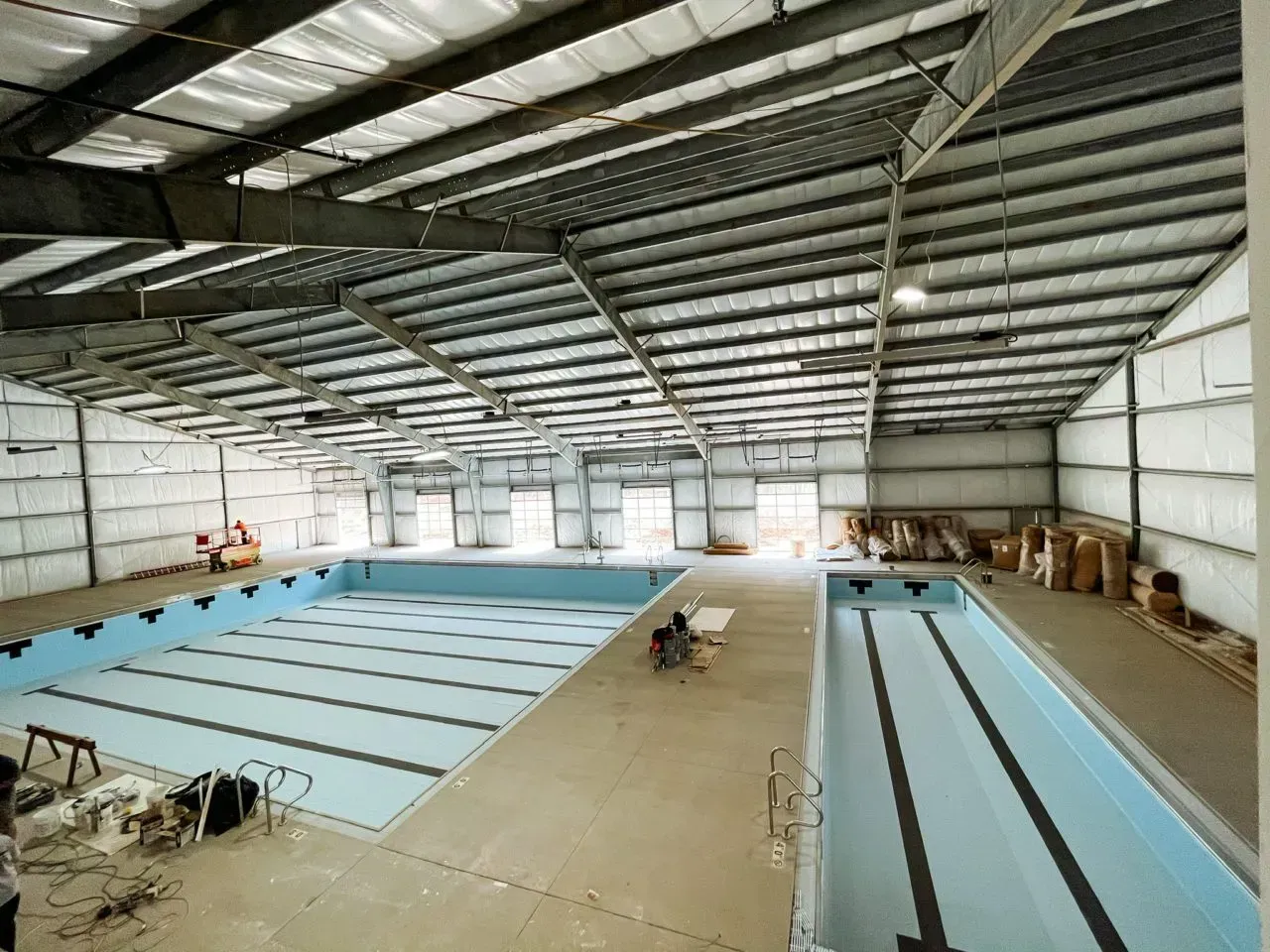 A large indoor swimming pool is under construction