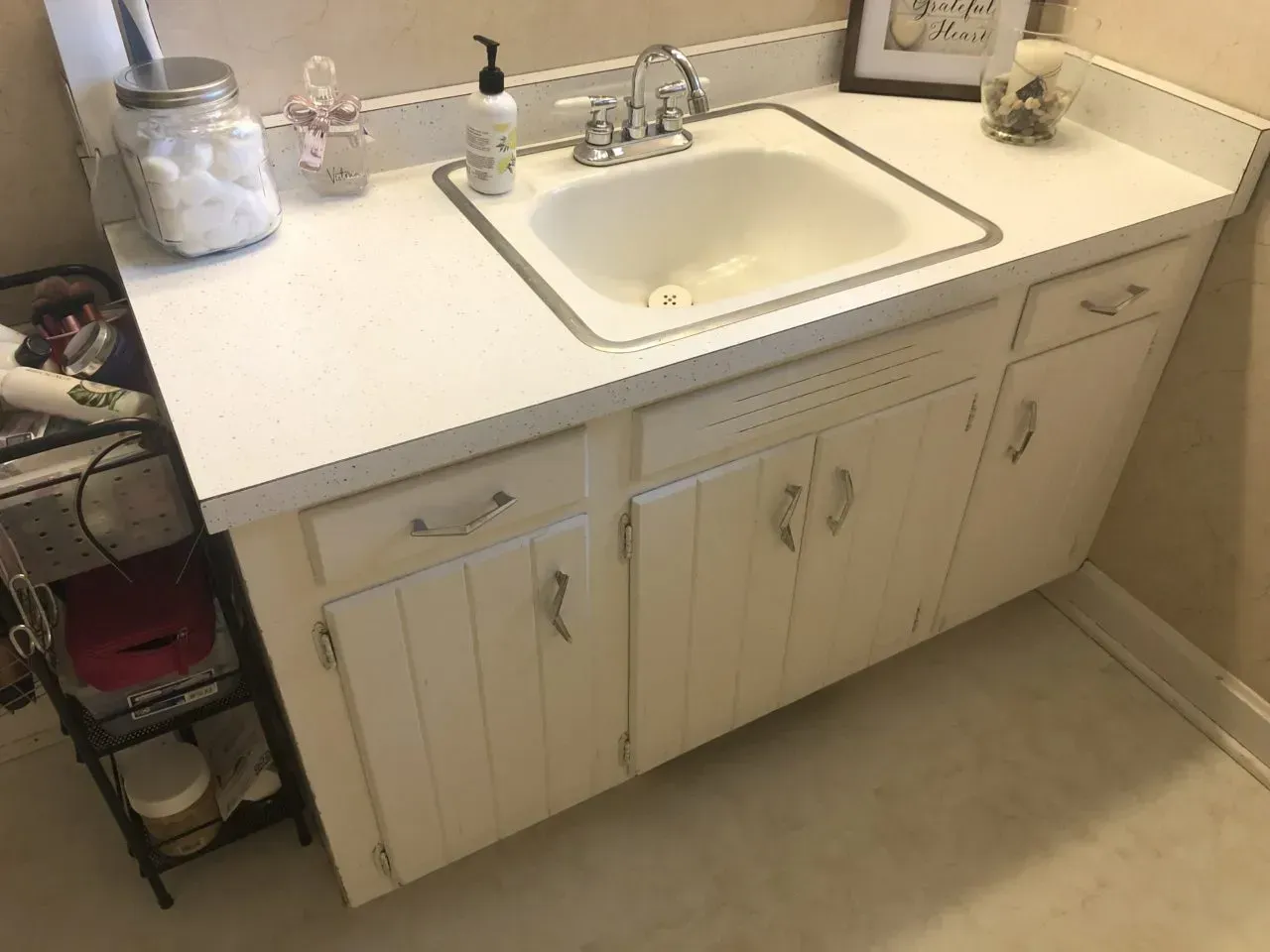 A bathroom vanity with a sink and cabinets