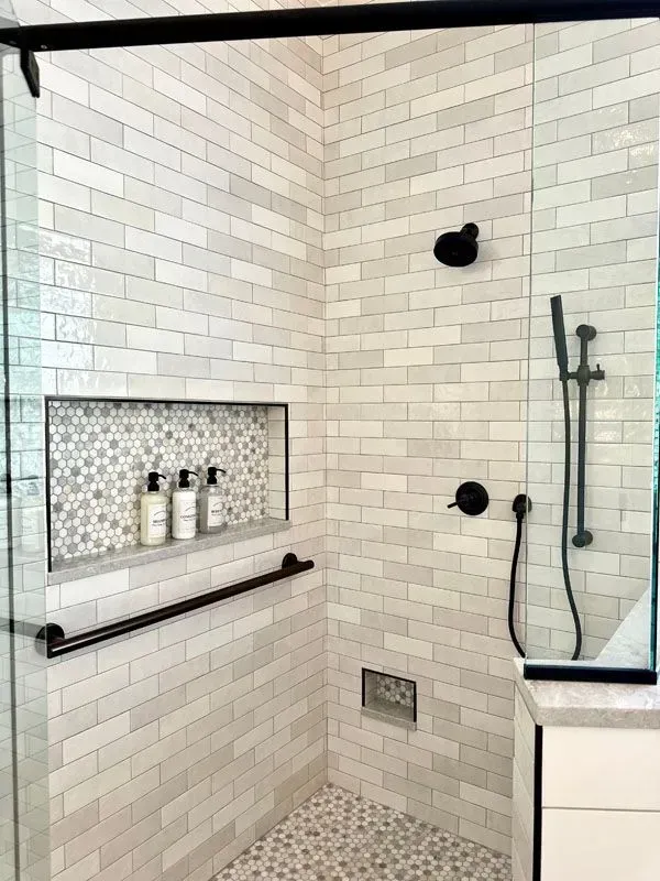 A bathroom with a walk in shower and a sliding glass door.