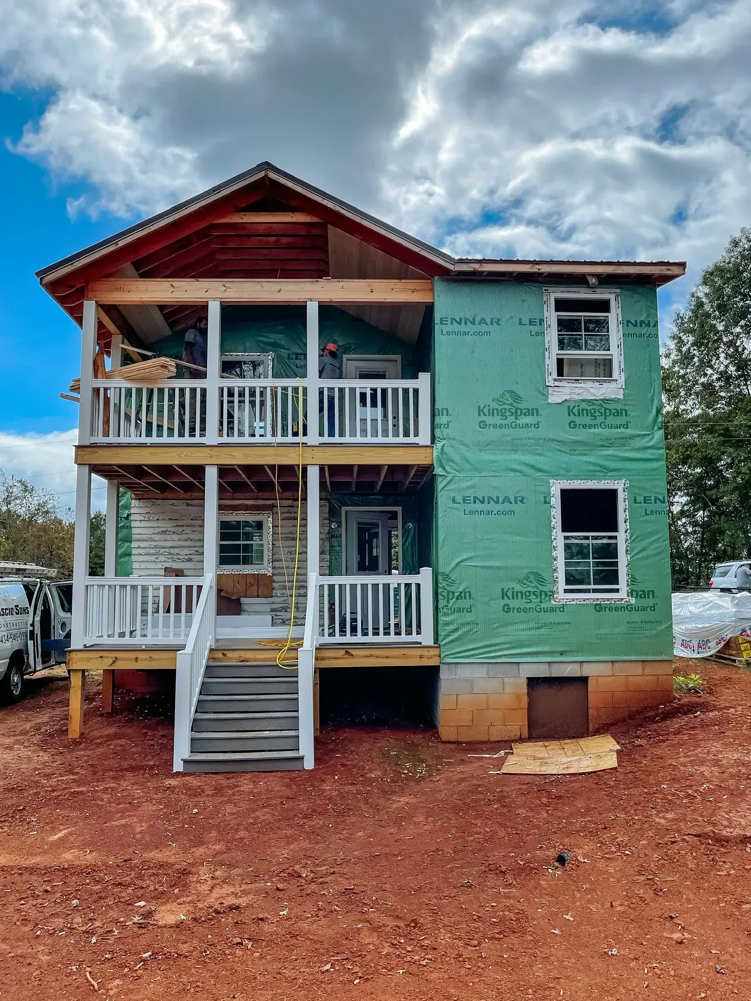 A house is being built with green insulation and a large porch.