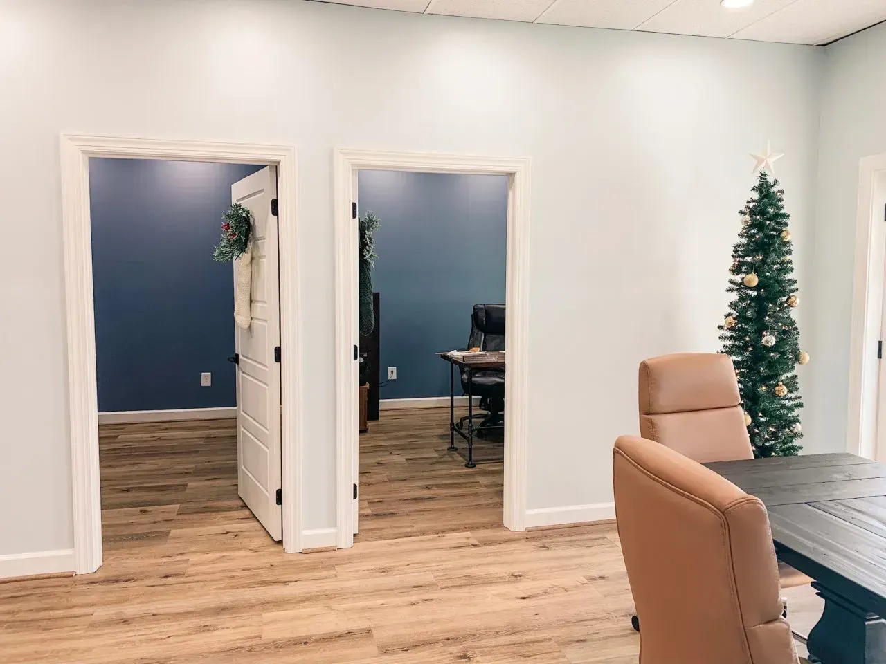 There is a christmas tree in the middle of the room.