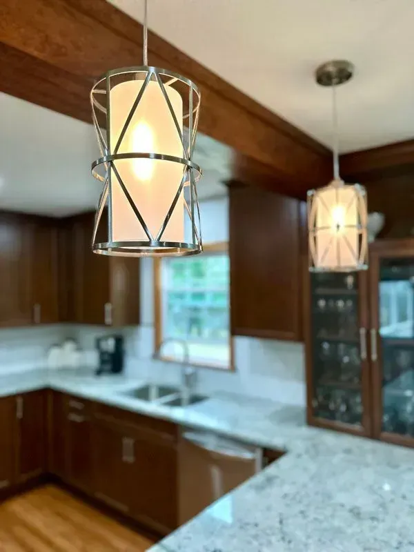 A kitchen with a light hanging from the ceiling