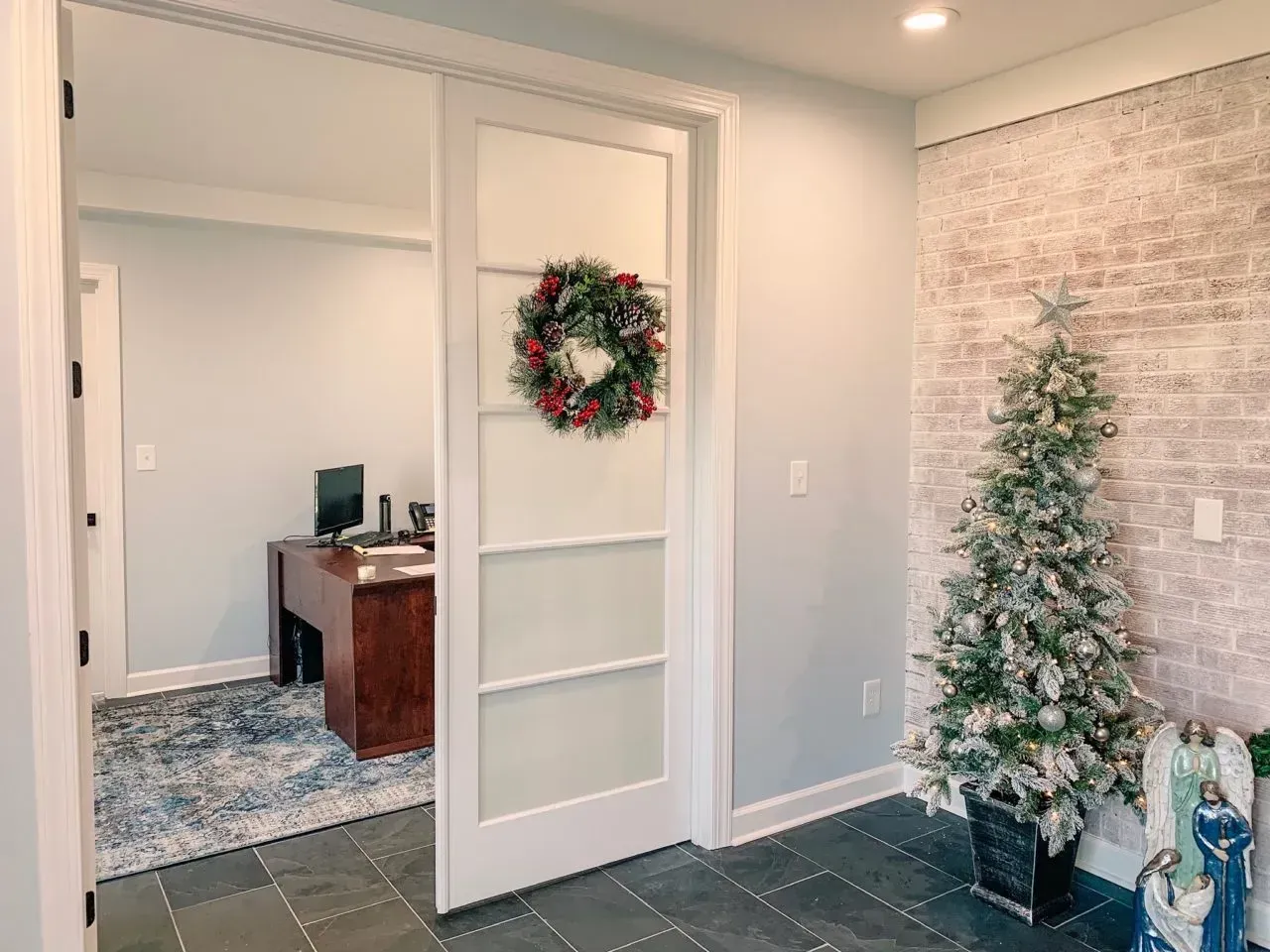 There is a christmas tree in the middle of the room.