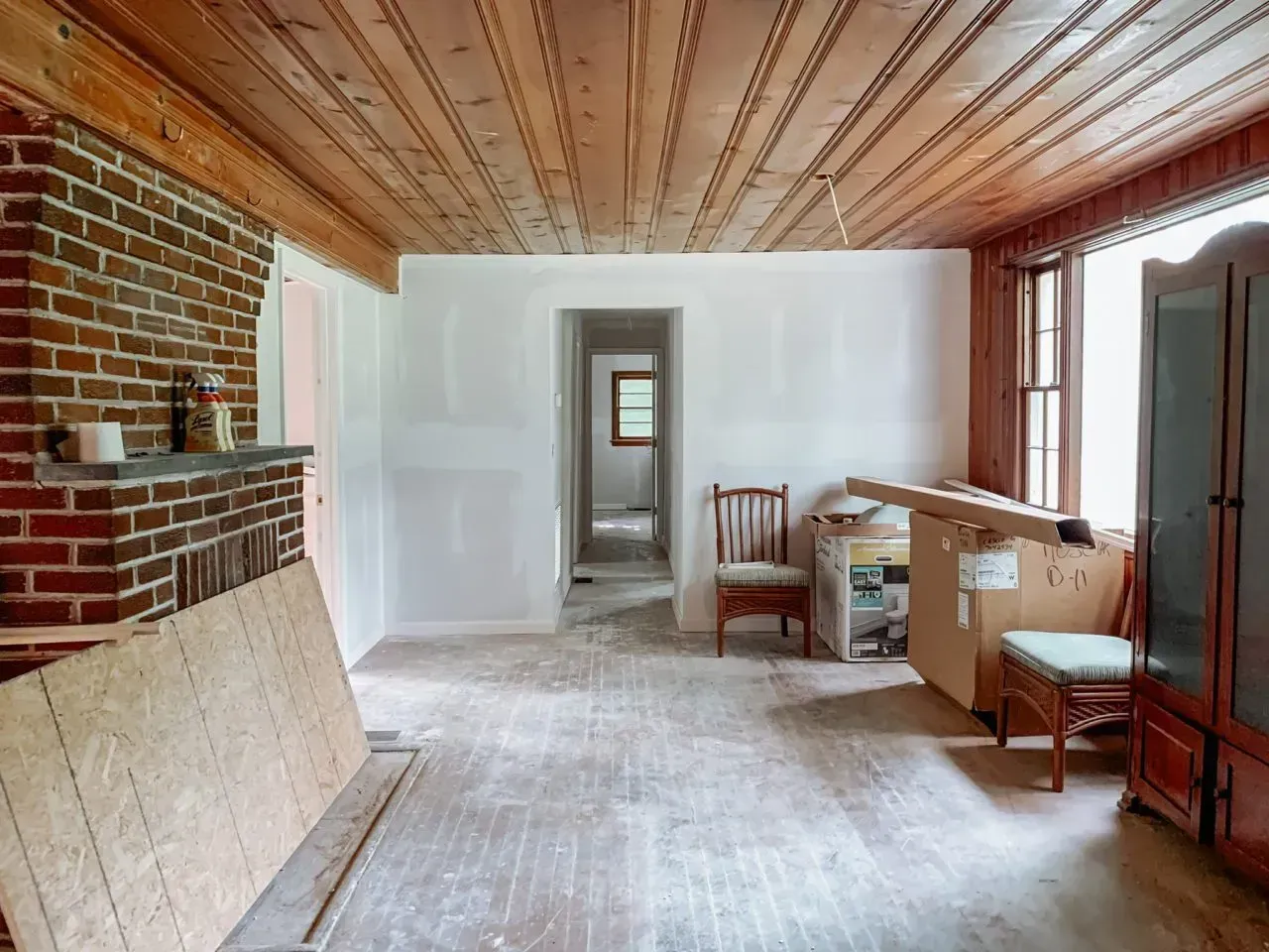 There is a brick fireplace in the middle of the room.