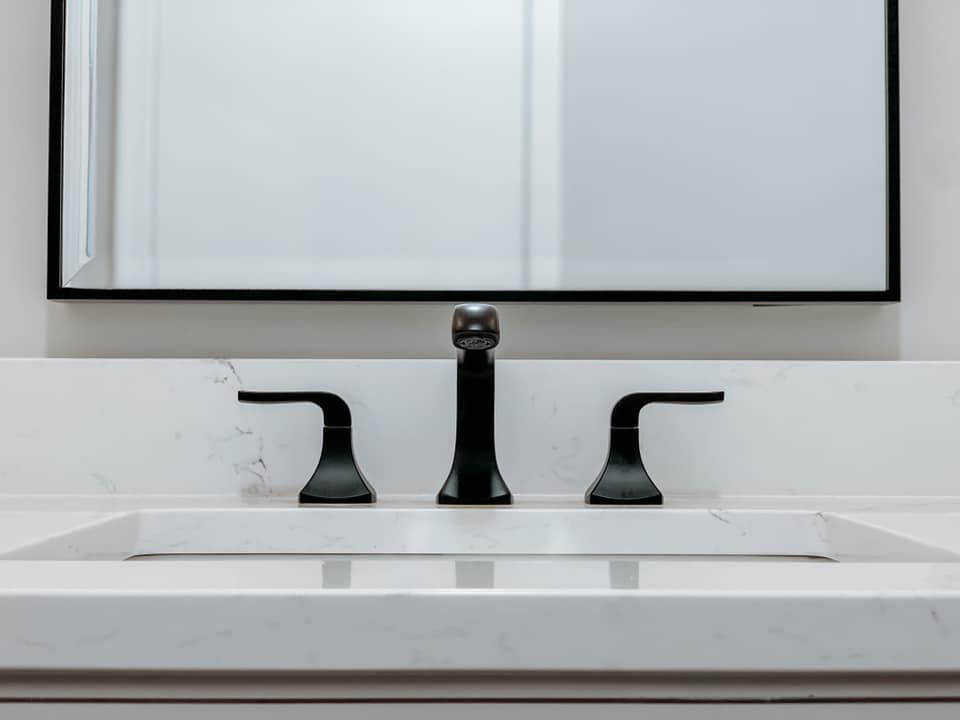 A bathroom sink with a mirror above it and a faucet.