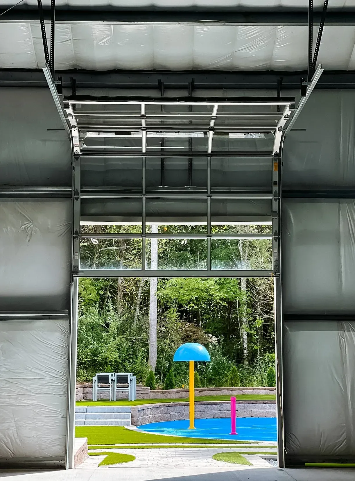 A view of a water park through an open garage door.