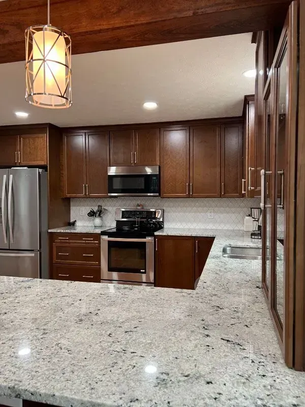 A kitchen with granite counter tops and stainless steel appliances