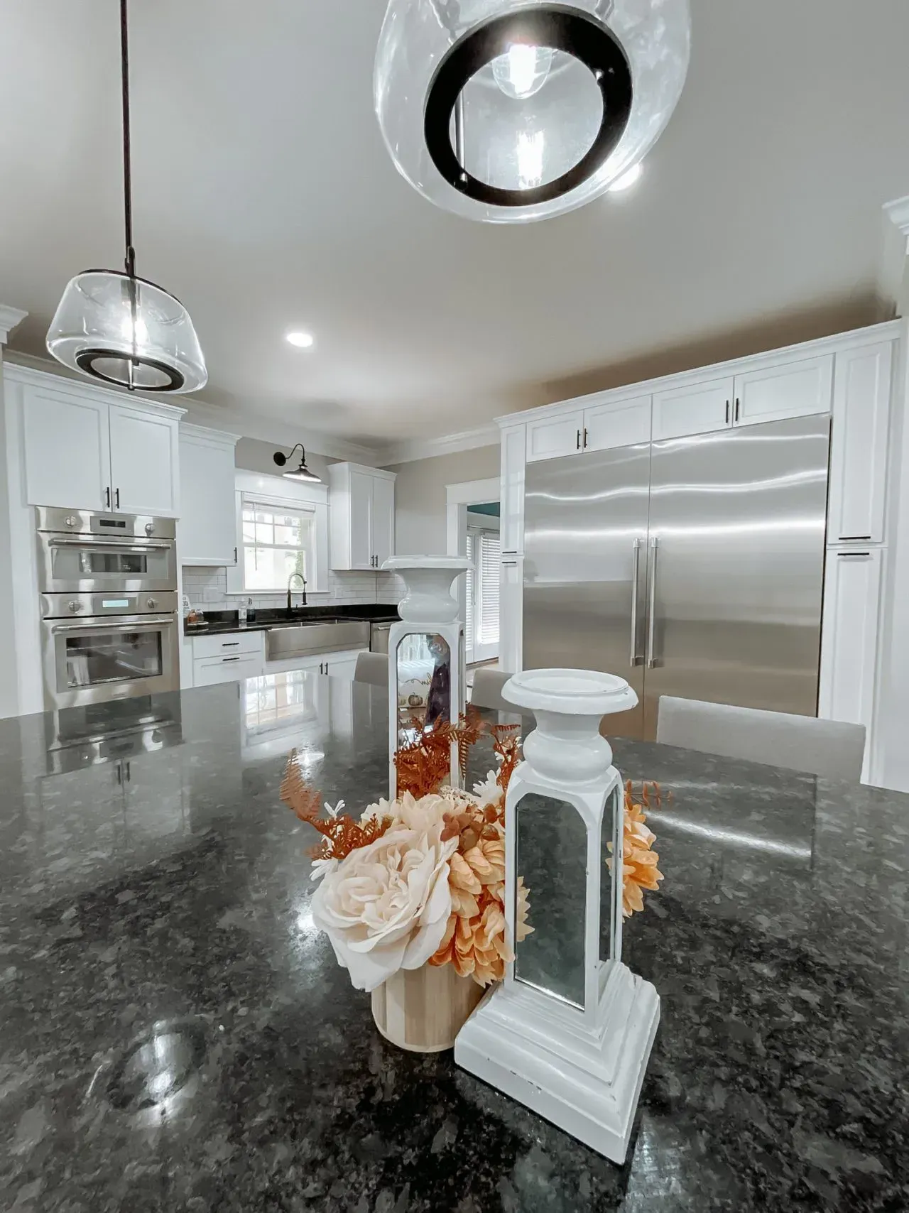 A kitchen with stainless steel appliances and a black granite counter top.