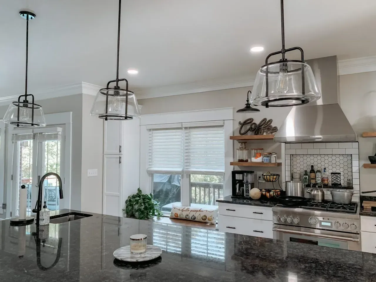 A kitchen with stainless steel appliances , granite counter tops , and a large island.