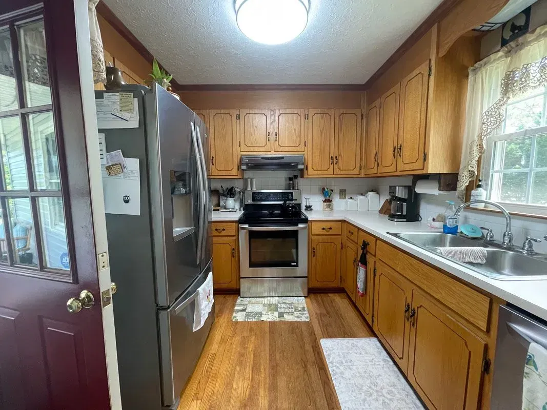 A kitchen with wooden cabinets and stainless steel appliances.