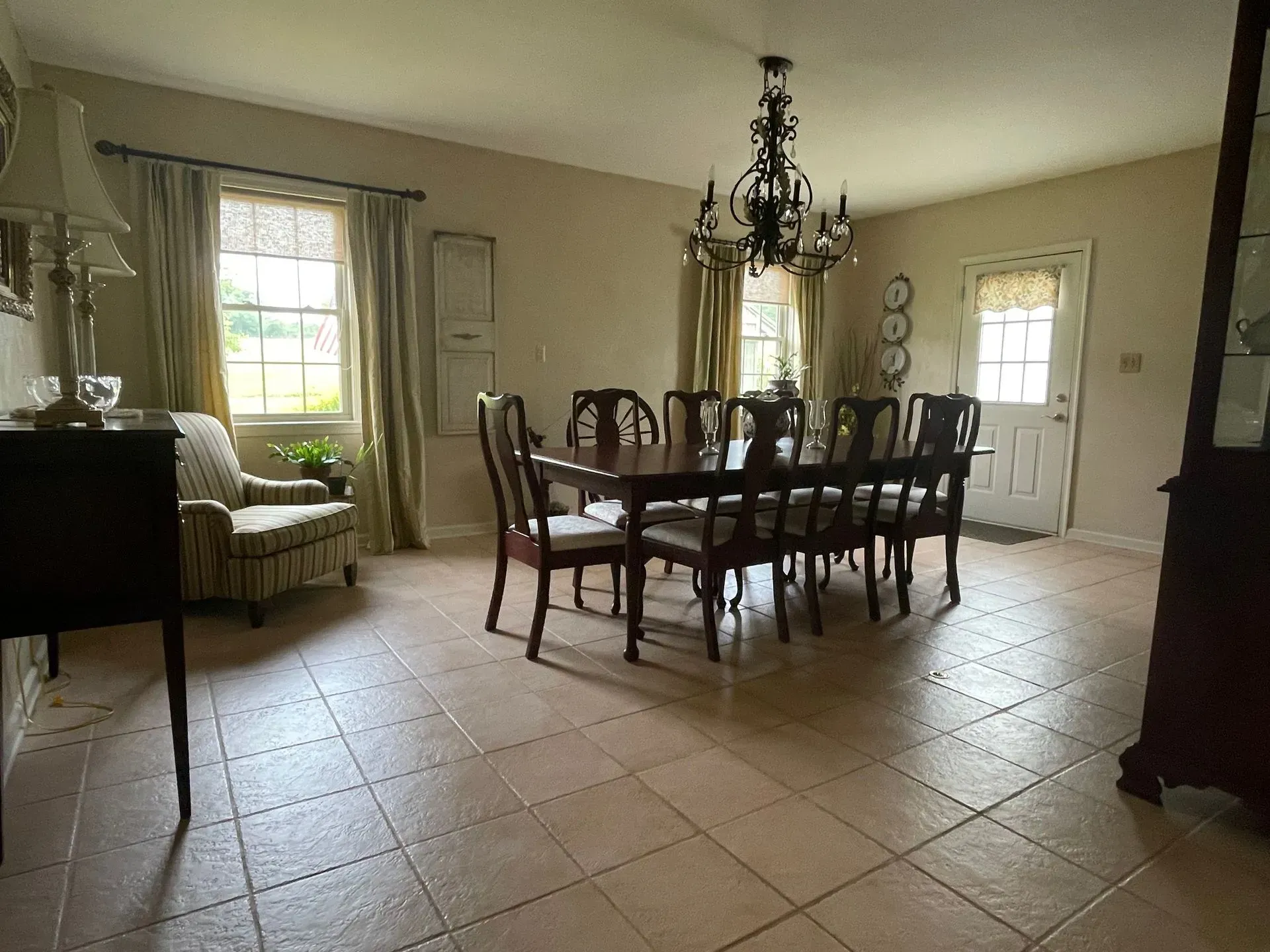A dining room with a table and chairs and a chandelier