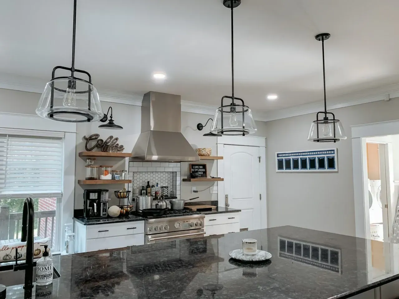 A kitchen with a large island and stainless steel appliances.