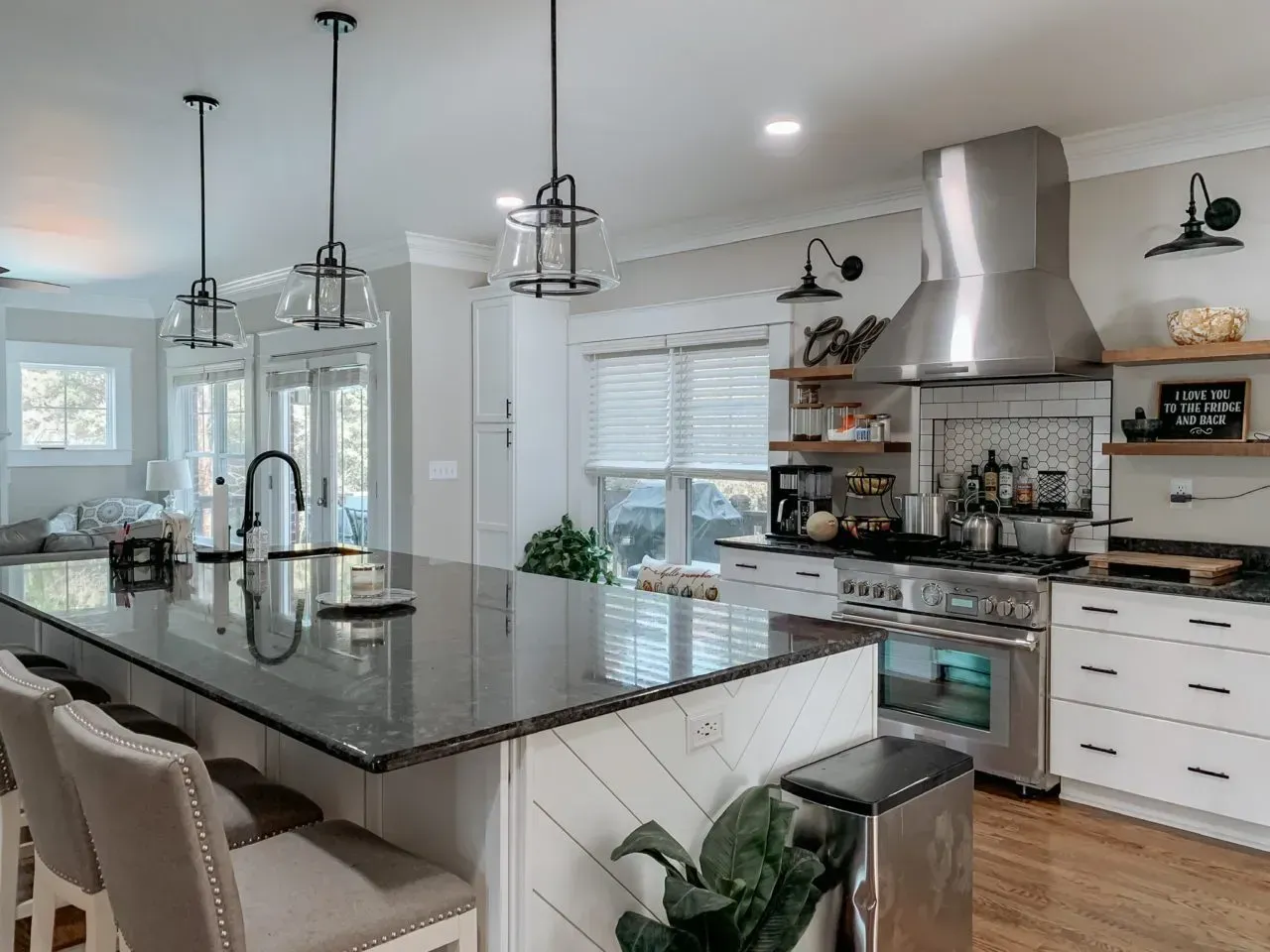 A kitchen with a large island and stainless steel appliances.