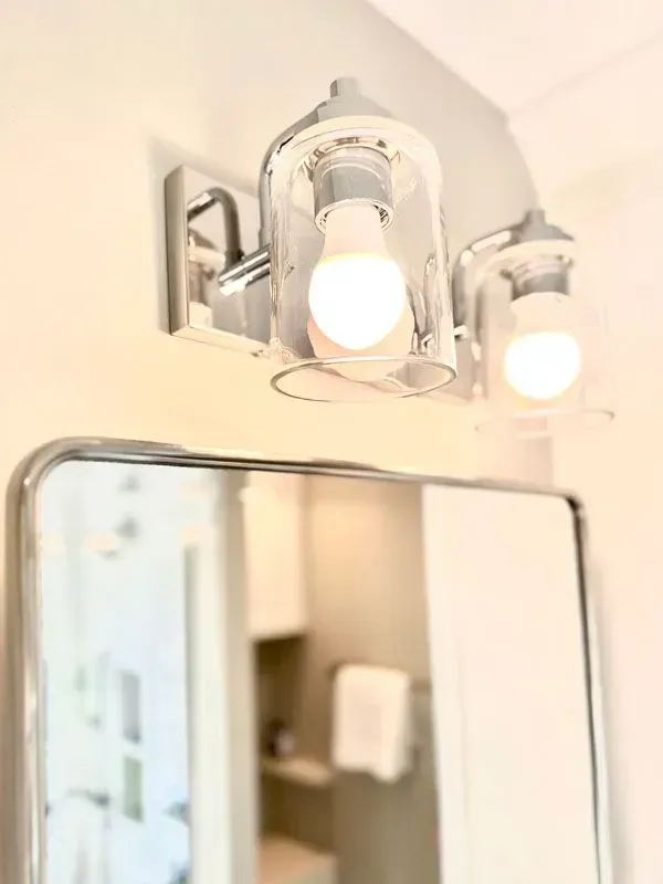 A bathroom vanity light is hanging above a mirror.