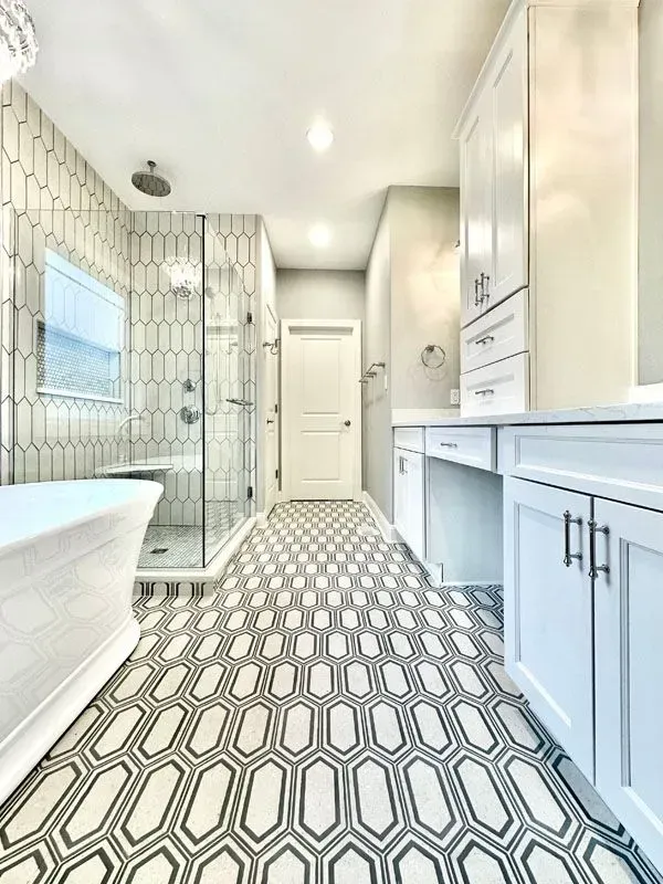 A bathroom with a bathtub , sink , and shower.