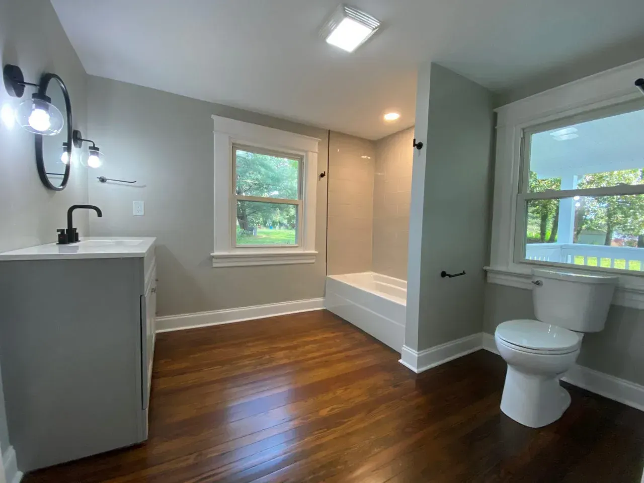 A bathroom with a toilet , sink , and bathtub.