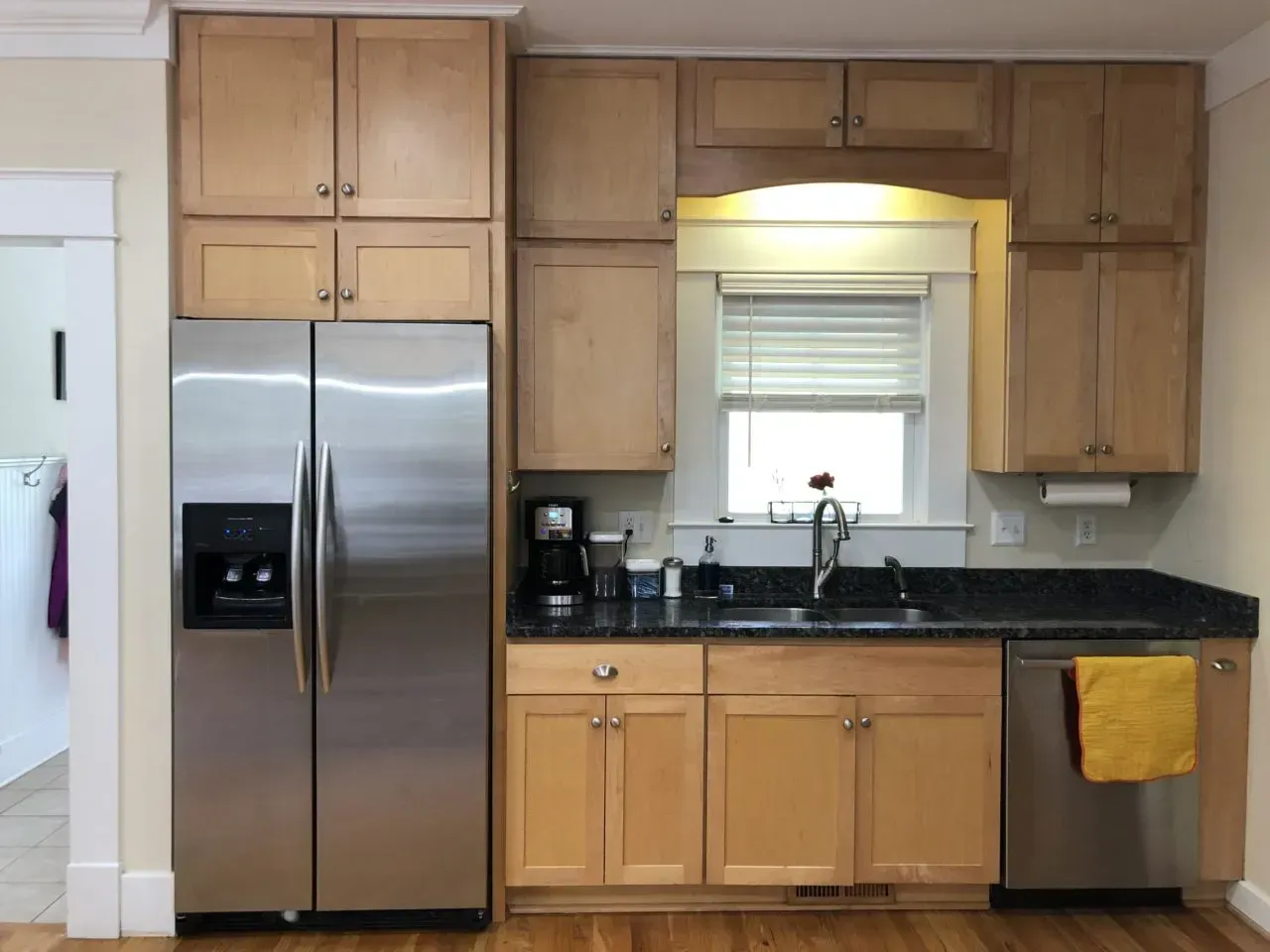 A kitchen with stainless steel appliances and wooden cabinets