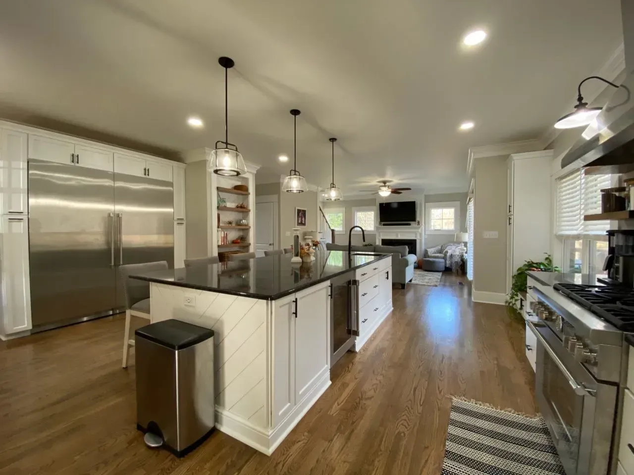 A kitchen with a large island and stainless steel appliances.