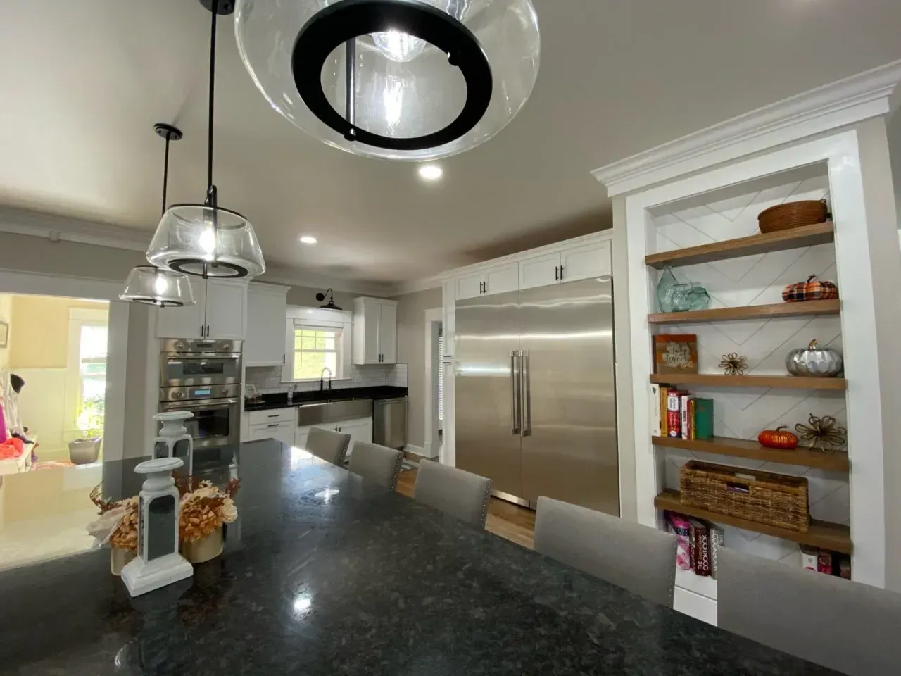A kitchen with stainless steel appliances and a dining table