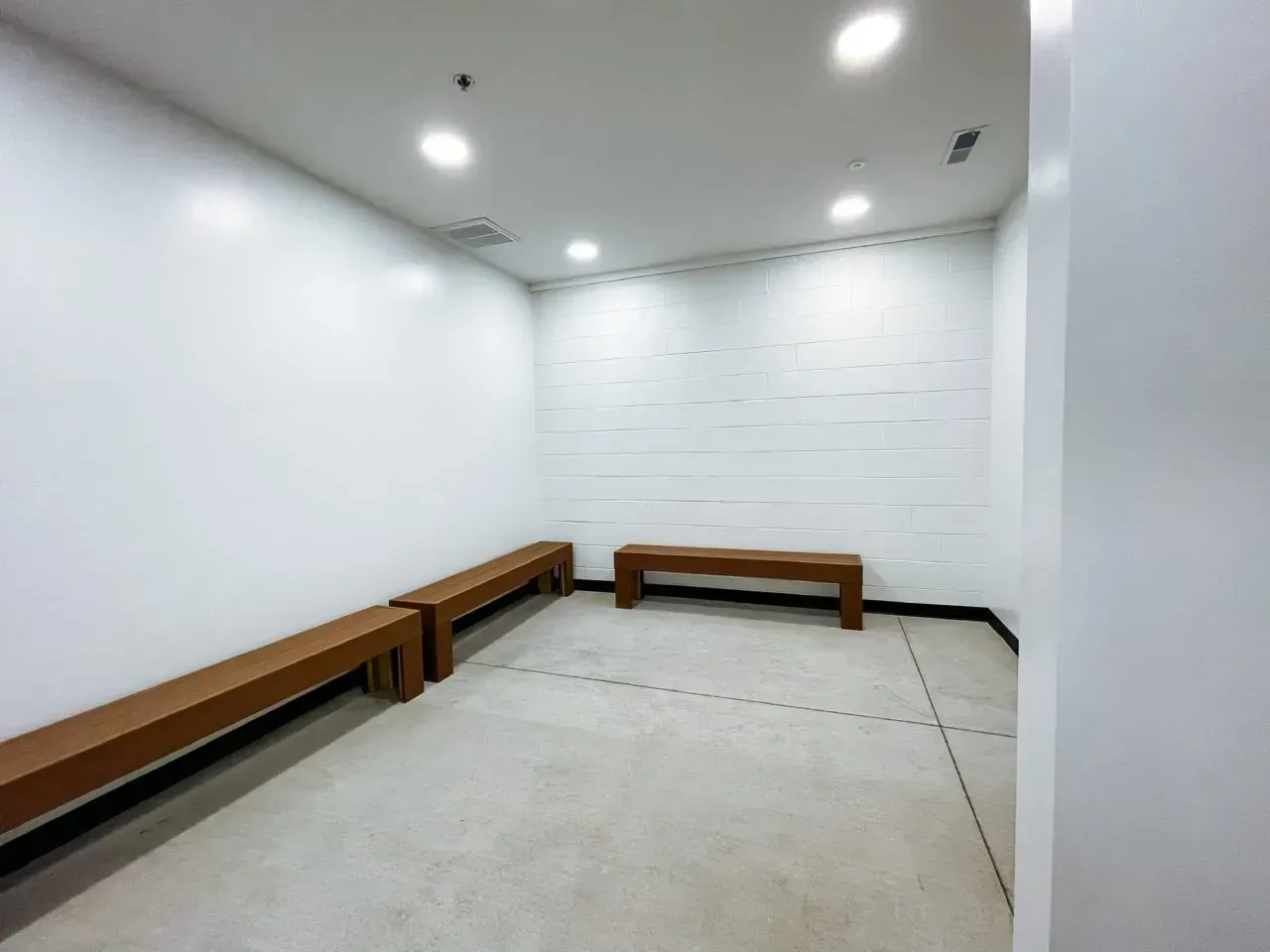 An empty room with two wooden benches in it