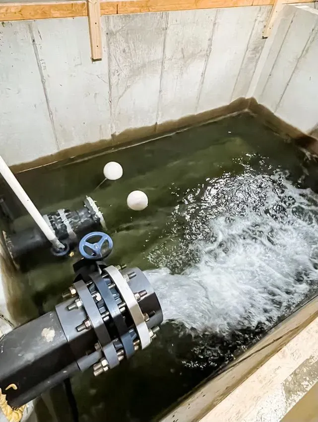 A pipe is coming out of a tank of water.