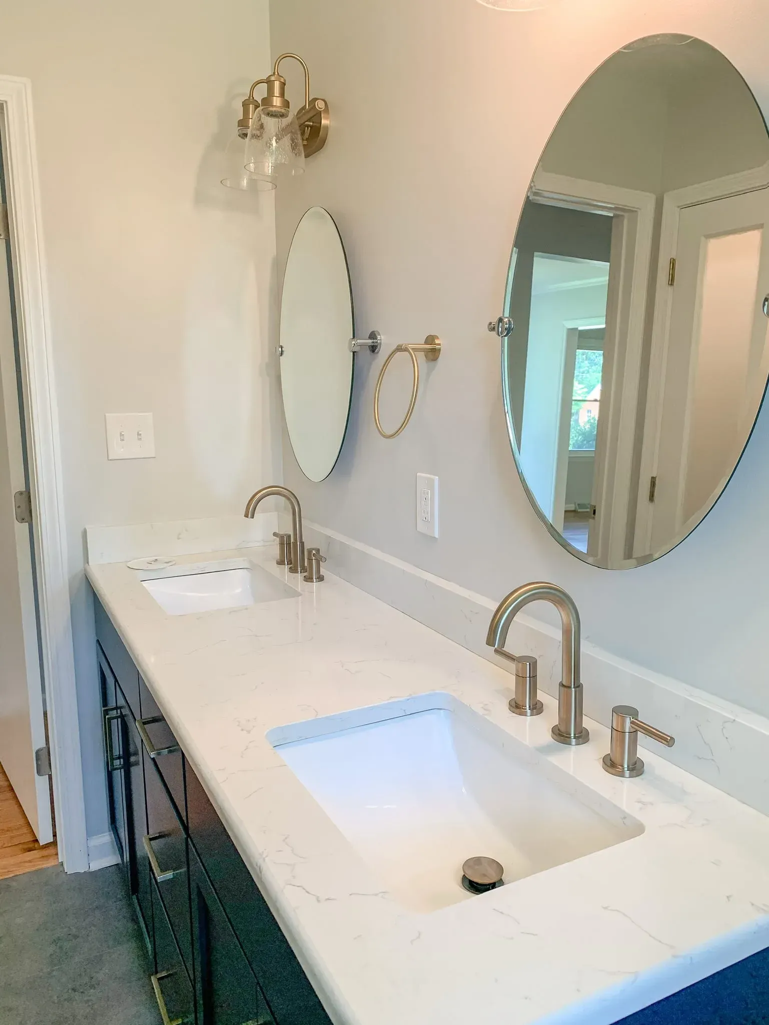 A bathroom with two sinks and two mirrors.