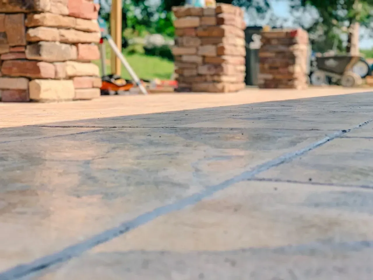 A close up of a tiled floor with brick pillars in the background.