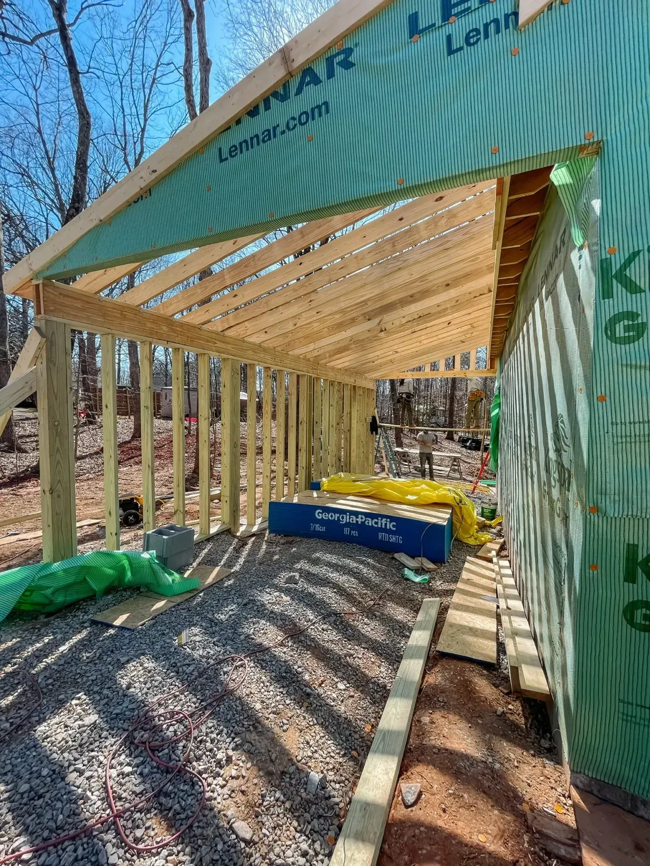 A wooden structure is being built in the woods.