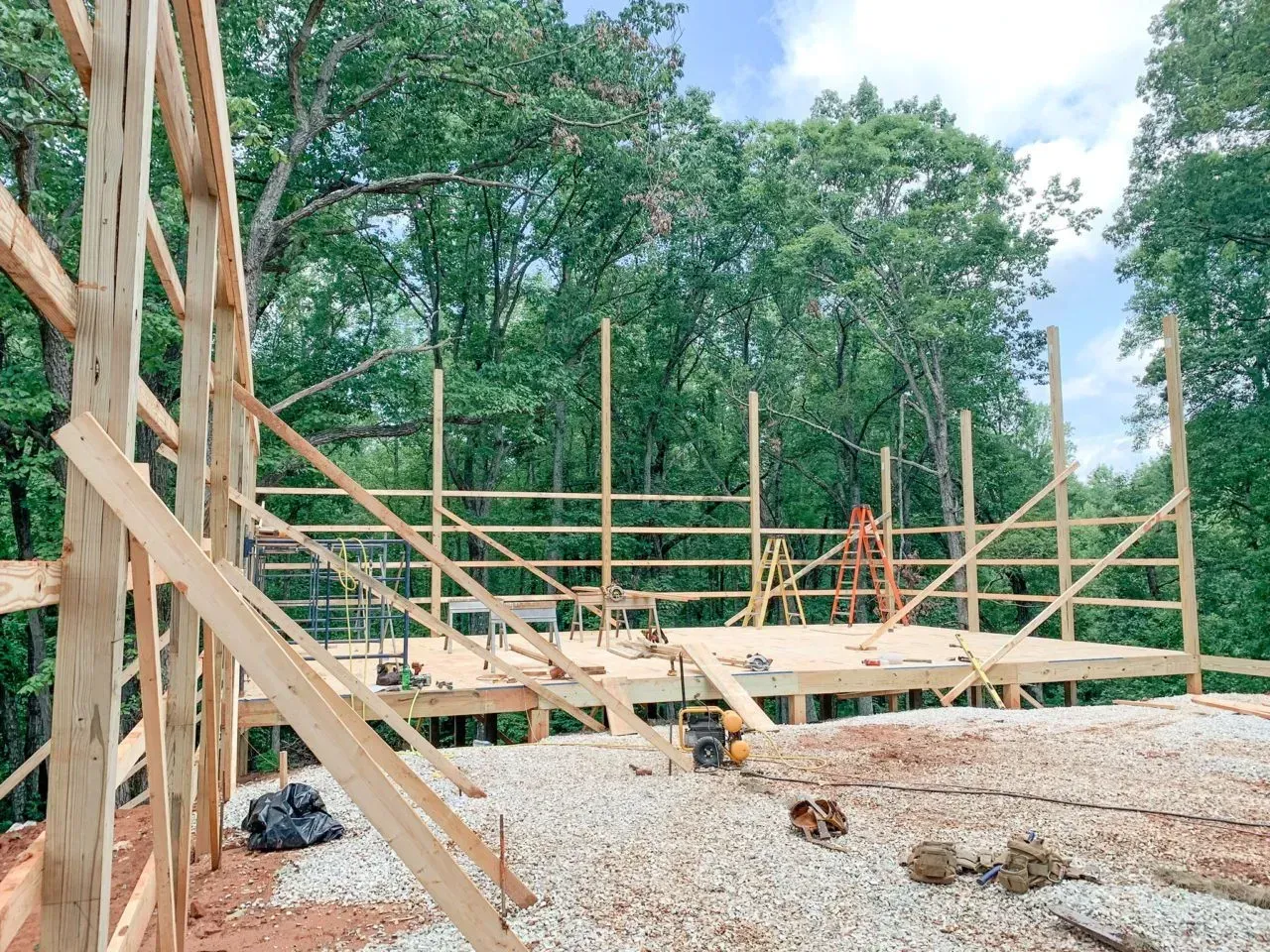 A wooden structure is being built in the middle of a forest.