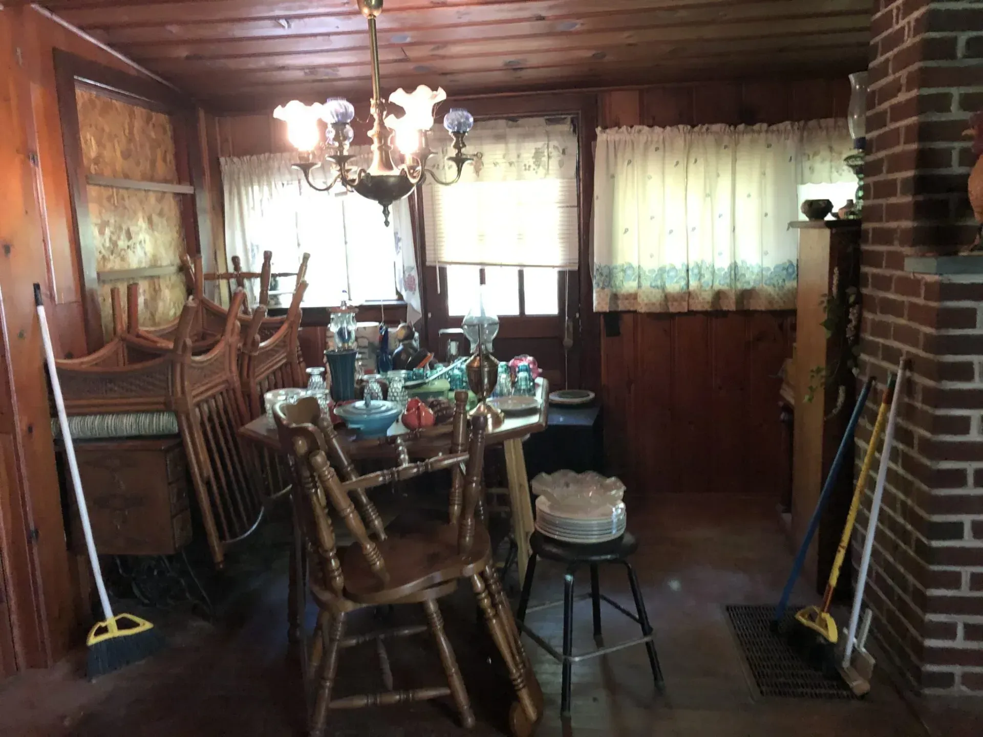 A dining room with a table and chairs and a chandelier.