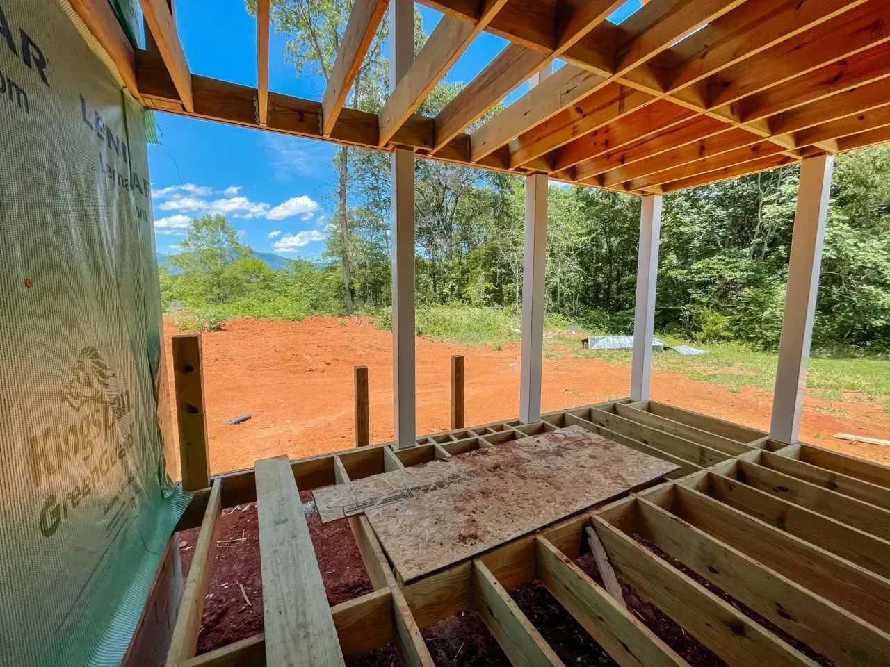 A wooden deck is being built in a house under construction.