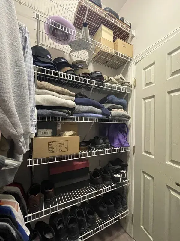 A walk in closet filled with clothes and shoes.