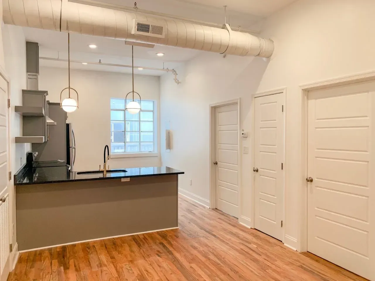 There is a kitchen in the middle of the room.