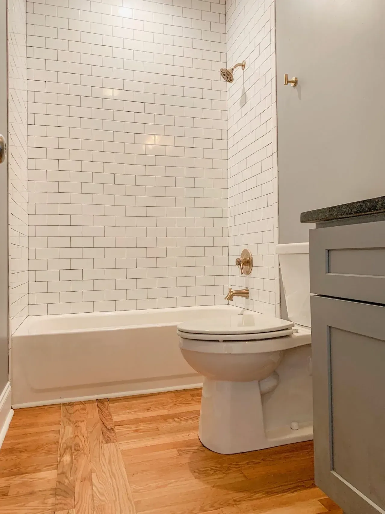 A bathroom with a toilet , bathtub and shower.