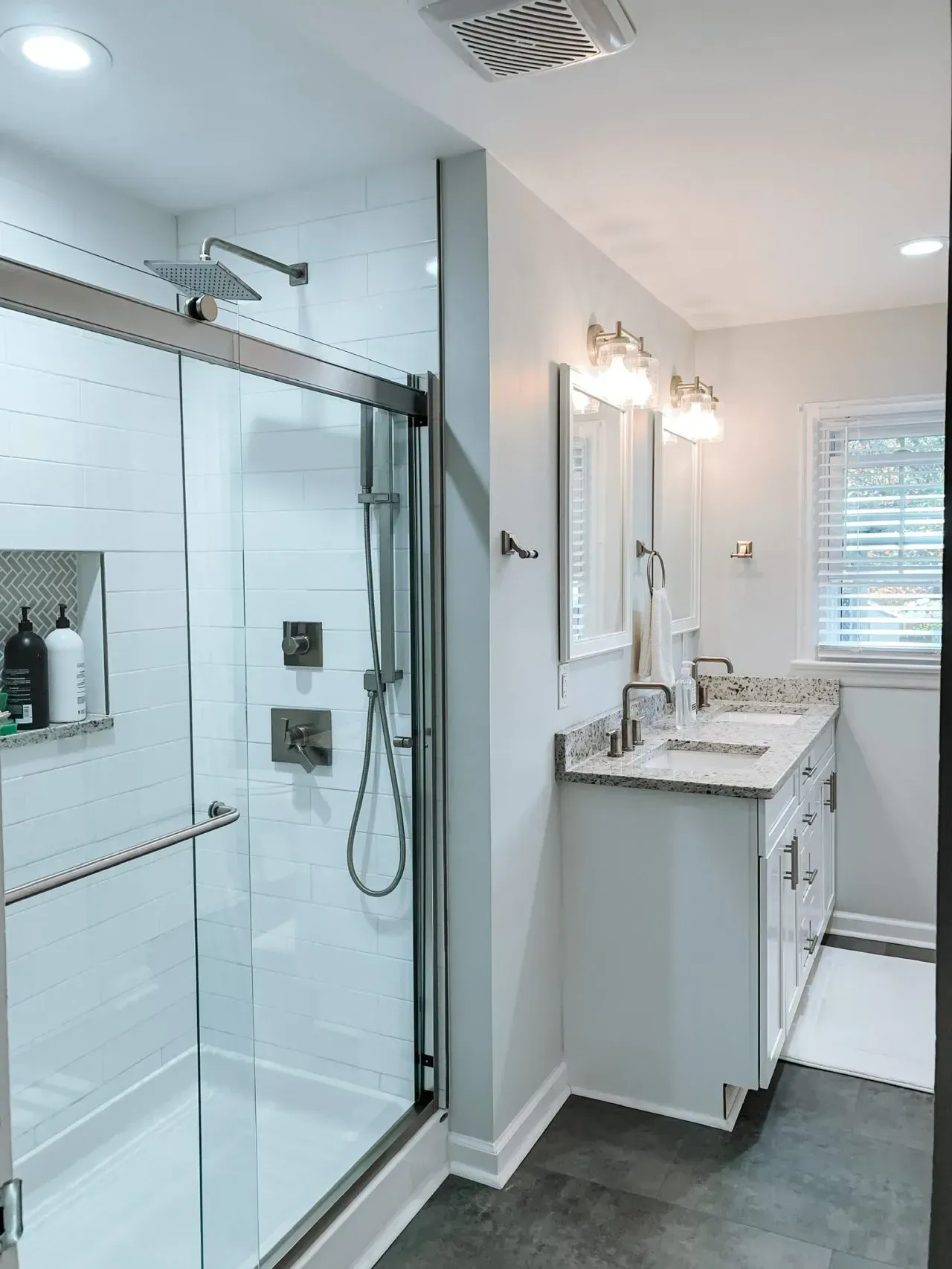 A bathroom with a sliding glass shower door and a sink.