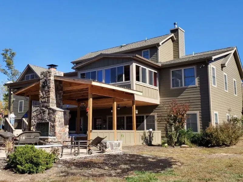 A large house with a covered porch and a fireplace